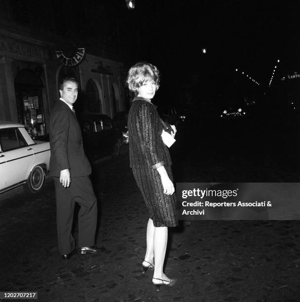 Italian acress Monica Vitti and Italian director Michelangelo Antonioni attending to an award ceremony. 1957