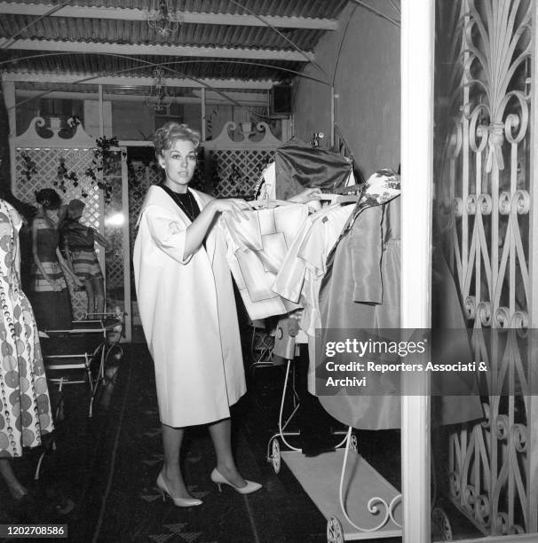 American actress Kim Novak choosing some dresses designed by Sorelle Fontana fashion house, established by sisters and Italian fashion designers Zoe,...