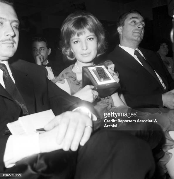 Italian acress Monica Vitti and Italian director Michelangelo Antonioni attending to an award ceremony. 1957