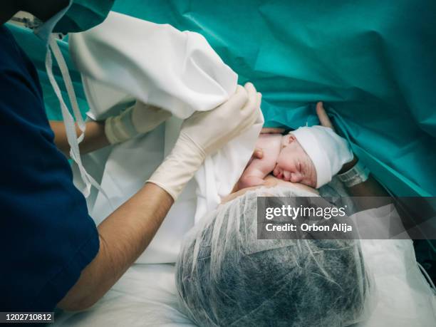 mother giving birth to a baby - new life stock pictures, royalty-free photos & images