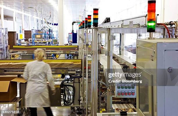 An employee monitors the Lindt chocolate praline packaging line inside the Lindt & Spruengli AG factory in Kilchberg, near Zurich, Switzerland, on...