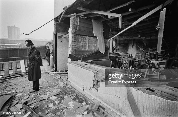 Police officer stands before the damage caused by one of the two pub bombings which hit the city on 21st November 1974, in Birmingham, West Midlands,...