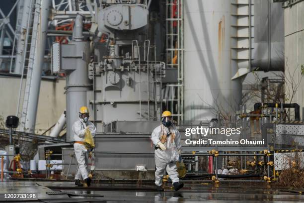 Workers walk through Tokyo Electric Power Co.'s Fukushima Dai-ichi nuclear power plant on January 29, 2020 in Okuma, Fukushima Prefecture, Japan....