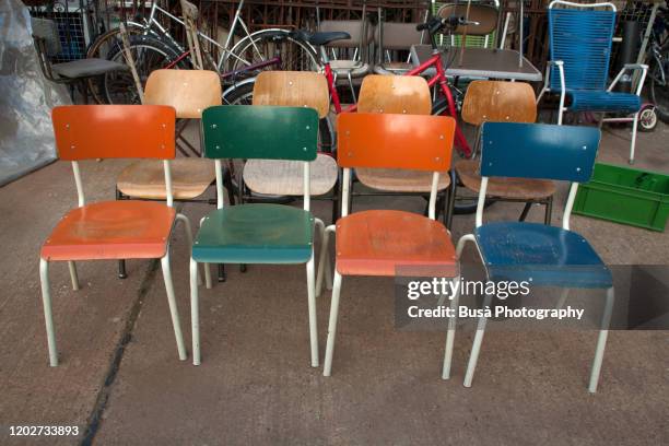 vintage chairs for sale in a flea market in berlin, germany - furniture stockfoto's en -beelden