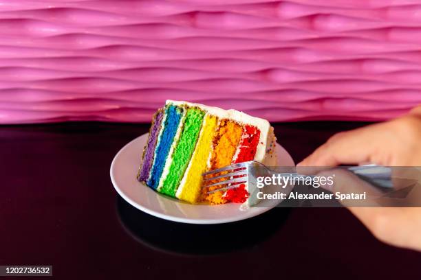 eating rainbow colored cake, personal perspective view - cake flag stock pictures, royalty-free photos & images