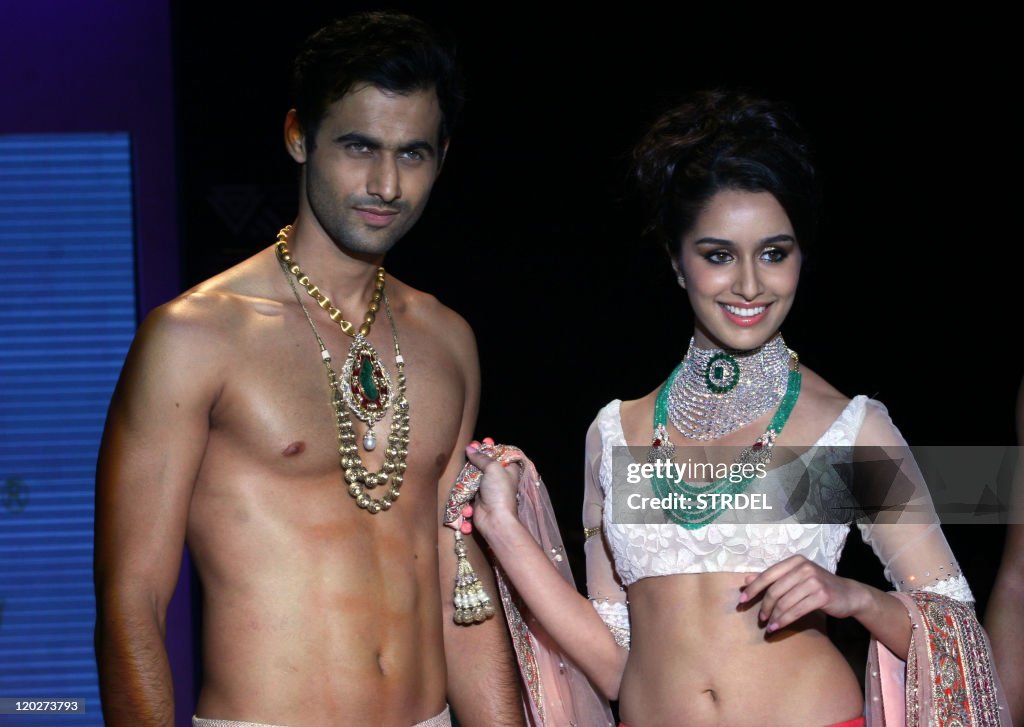 Indian Bollywood actress Shraddha Kapoor and a model display