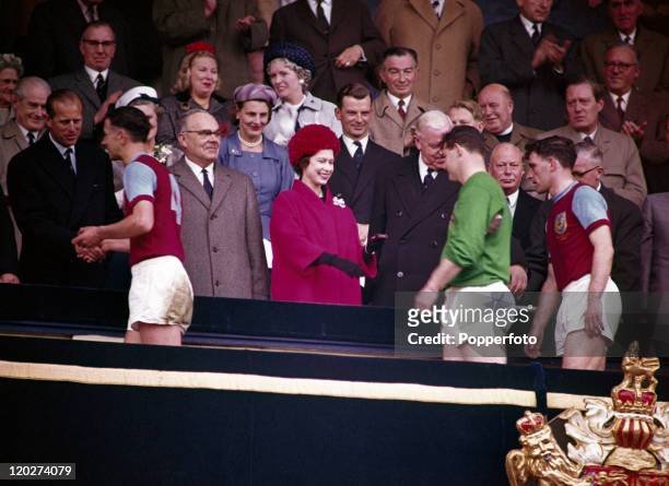 The Duke of Edinburgh and Queen Elizabeth II greet the Burnley football team after their 3-1 defeat by Tottenham Hotspur in the FA Cup Final at...