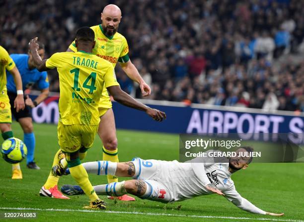 Nantes' Malian defender Charles Traore vies with Marseille's Argentine forward Dario Benedetto next to Nantes' French defender Nicolas Pallois during...