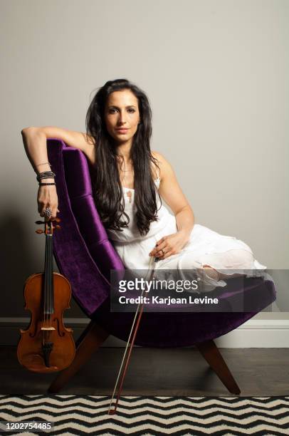 Violinist Asha Mevlana poses for a portrait with her violin on May 10, 2014 in New York City, New York.