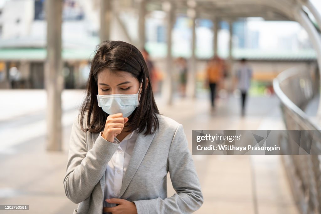 Young woman with face mask in the street