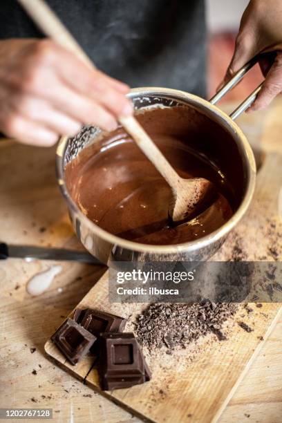 woman baking at home: melt chocolate - chocolate melting stock pictures, royalty-free photos & images