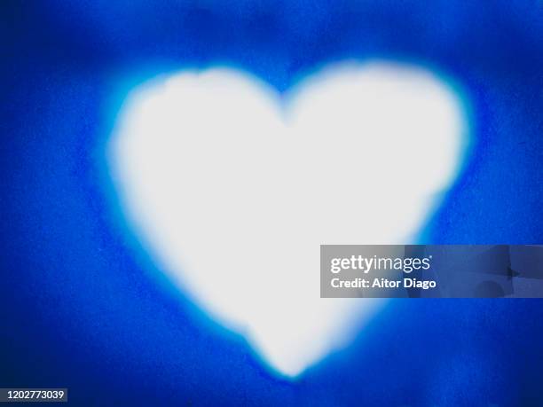 drawn of a heart shape in a blue paper. valentine's day - white construction paper texture stock pictures, royalty-free photos & images