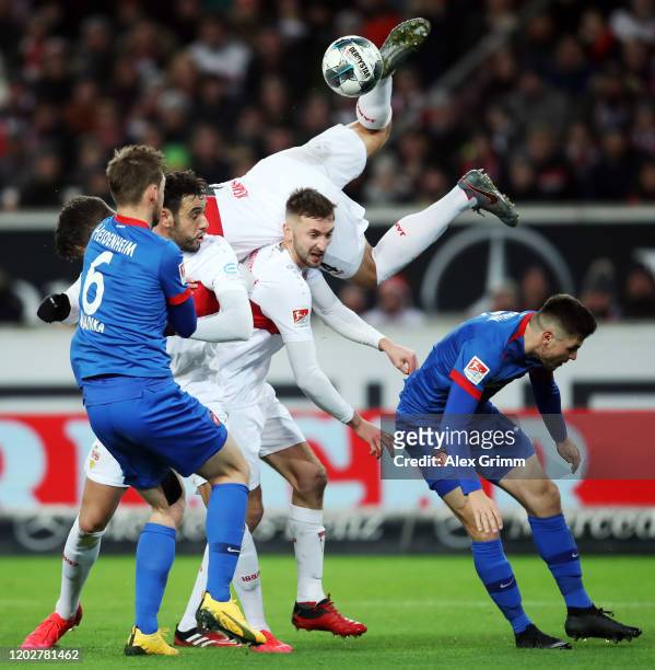 Hamadi Al Ghaddioui, Nathaniel Phillips and Marc-Oliver Kempf of Stuttgart are challenged by Patrick Mainka and Marnon Busch of Heidenheim during the...