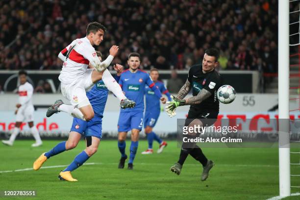 Marc-Oliver Kempf of Stuttgart scores his team's first goal past goalkeeper Kevin Mueller of Heidenheim during the Second Bundesliga match between...