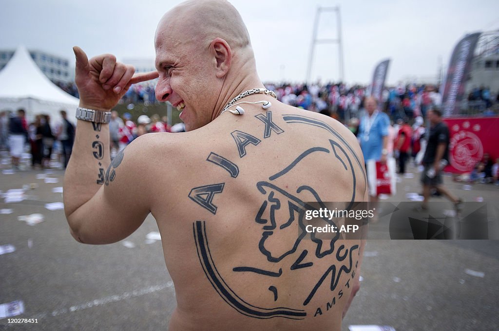 An Amsterdam Ajax football fan shows off