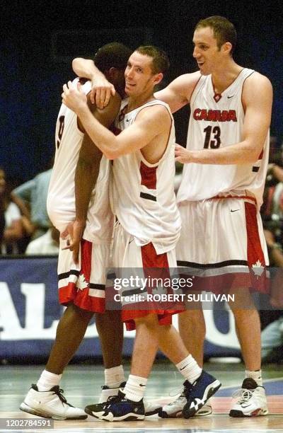 Rowan Barrett , Steve Nash and Peter Guarasci of Canada celebrate their 83-71 win over Puerto Rico during the final seconds of their semi-final game...