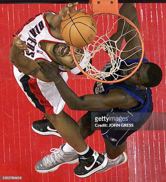 Portland Trail Blazer Rasheed Wallace dunks the ball on Dallas Maverick Michael Finley during the first half 02 May 2003 in Portland, Oregon. AFP...