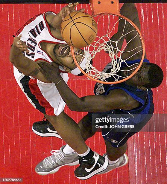 Portland Trail Blazer Rasheed Wallace dunks the ball on Dallas Maverick Michael Finley during the first half 02 May 2003 in Portland, Oregon. AFP...