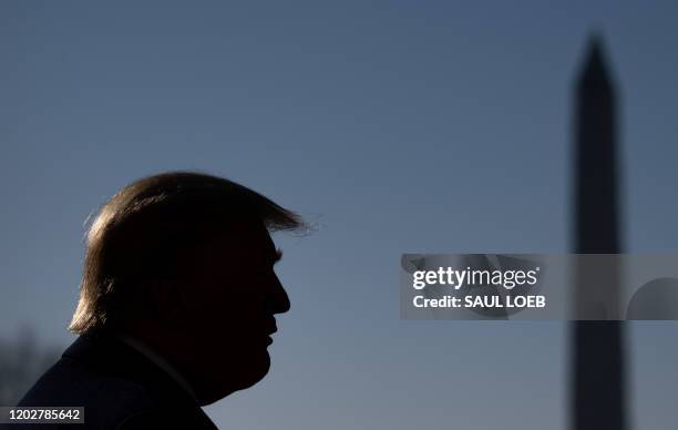 President Donald Trump speaks to the press prior to departing on Marine One from the South Lawn of the White House in Washington, DC, February 23...