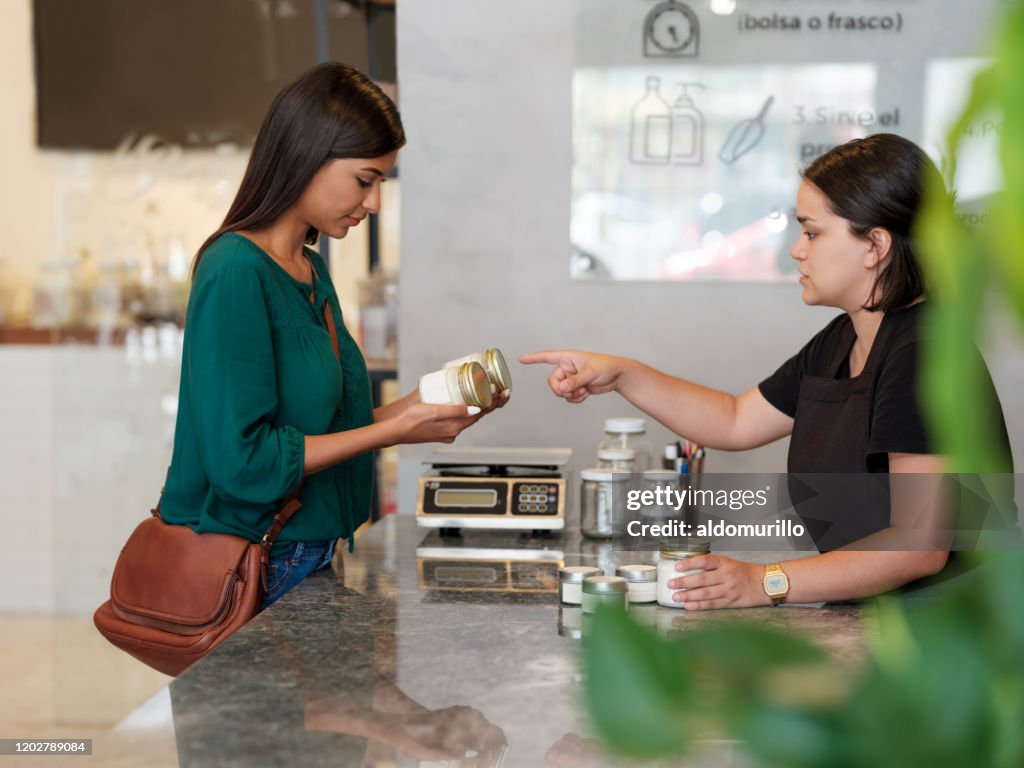 Female Costumer Female Costumer Bringing Products To The Counter High-Res Stock Photo ...