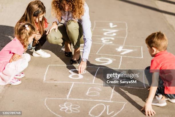 preparing for hopscotch - street games stock pictures, royalty-free photos & images