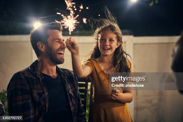 de nacht bleek sprankelend plezier - family fireworks stockfoto's en -beelden