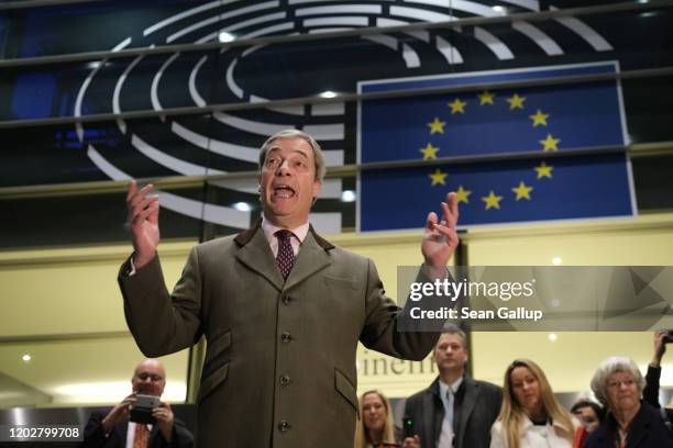 Brexit Party leader and member of the European Parliament Nigel Farage speaks to the media as he departs following a historic vote for the Brexit...