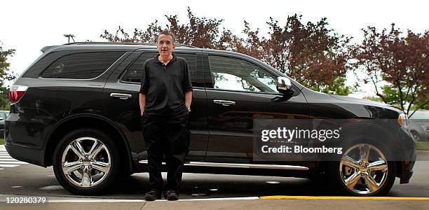 Sergio Marchionne, chief executive officer of Chrysler Group LLC and chairman of Fiat SpA, stands for a photograph in front of a Chrysler Dodge...