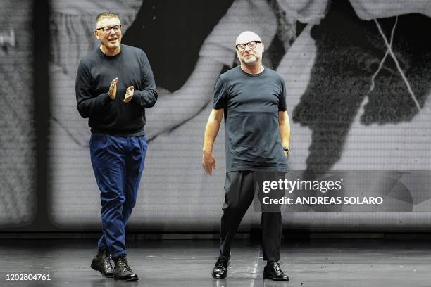 Italian fashion designers Domenico Dolce and Stefano Gabbana acknowledge applause following the presentation of their Women Fall - Winter 2020...