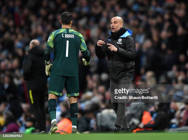 Pep Guardiola, Manager of Manchester City gives instructions to Claudio Bravo of Manchester City during the Carabao Cup Semi Final match between...