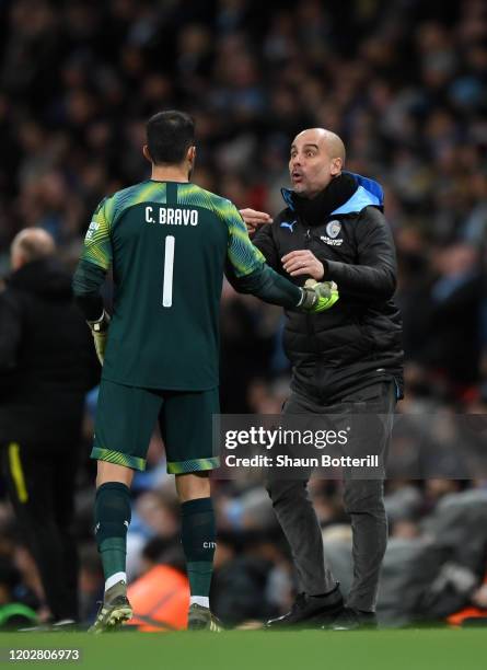 Pep Guardiola, Manager of Manchester City gives instructions to Claudio Bravo of Manchester City during the Carabao Cup Semi Final match between...