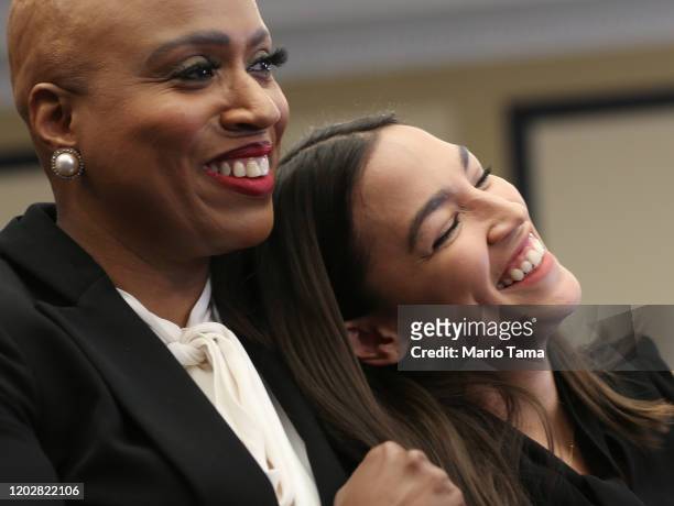 Rep. Alexandria Ocasio-Cortez and Rep. Ayanna Pressley embrace at a news conference introducing the 'People’s Housing Platform' on Capitol Hill on...