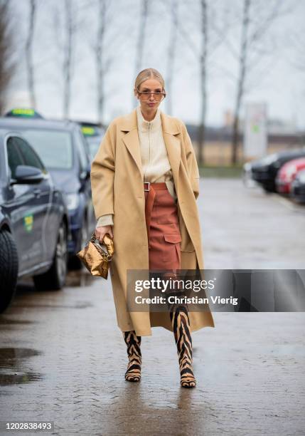 Leonie Hanne seen wearing Holzweiler sweater knit and skirt, Nanushka beige coat, Dires van Noten bag, Khaite boots with animal print, Zimmermann...