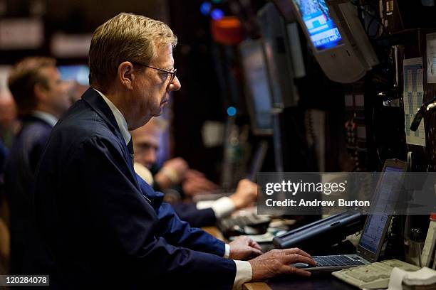 Trader works on the floor of the New York Stock Exchange during afternoon trading on August 3, 2011 in New York City. The Dow closed 29 points up...