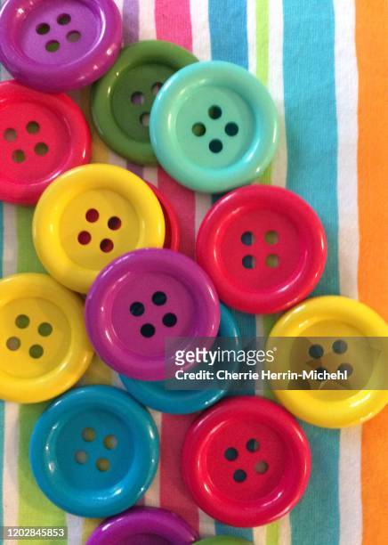 colorful, happy and brightred, teal, yellow, purple and green. close-up and fun. cheerful, happy and upbeat. crafting, children, or adults who enjoy fun will enjoy this arrangement of happiness. - button sewing item stock-fotos und bilder