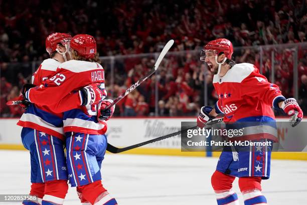 Carl Hagelin of the Washington Capitals celebrates with John Carlson and Brenden Dillon after scoring a goal against the Pittsburgh Penguins in the...