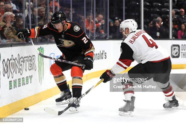 Niklas Hjalmarsson of the Arizona Coyotes defends against Carter Rowney of the Anaheim Ducks during the first period of game at Honda Center on...