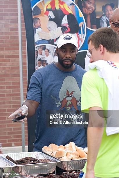 Mateen Cleaves, Piston Fox sports analyst, serves lunch to Boys and Girls Club members of Greater Flint, who are participating at a Carnival at their...