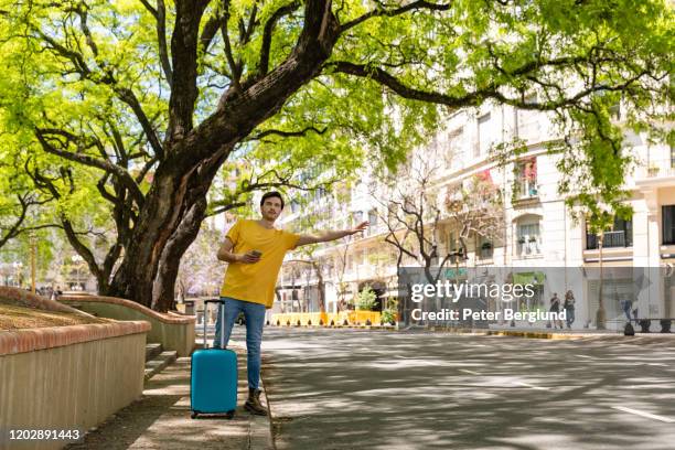 man hailing a cab in buenos aires - uber in buenos aires argentina stock pictures, royalty-free photos & images