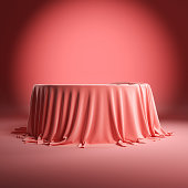 Round empty podium covered with rose cloth.