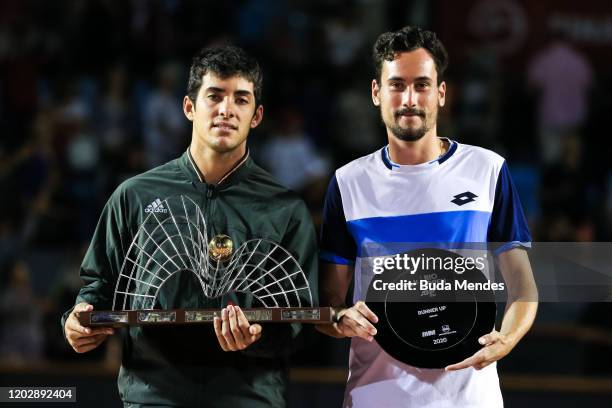 Cristian Garin of Chile and Gianluca Mager of Italy pose on the podium after the singles final of the ATP Rio Open the men's singles final match at...