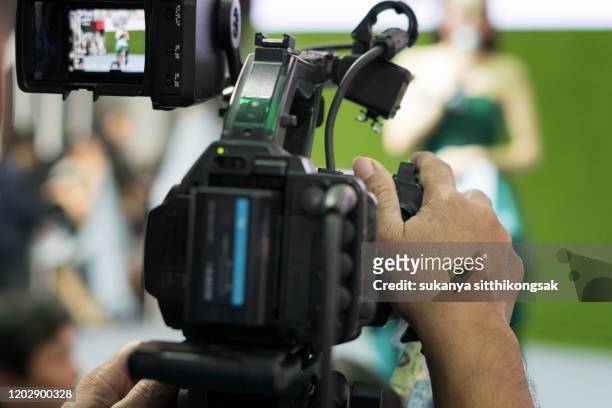man filming people through television camera.videoand shoot video concept. - film director foto e immagini stock