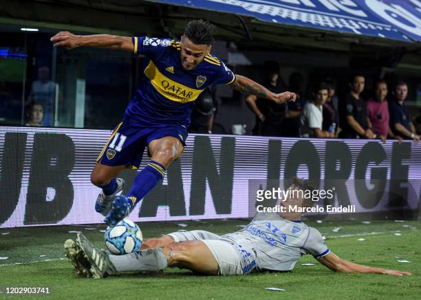 Eduardo Salvio of Boca Juniors fights for the ball with Gianluca Ferrari of Godoy Cruz during a match between Boca Juniors and Godoy Cruz as part of...