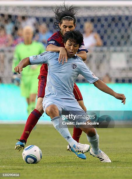 Fabian Espindola of Real Salt Lake battles Roger Espinoza of Sporting Kansas City for the ball during the game on August 3, 2011 at LiveStrong...