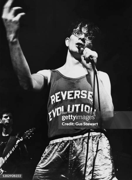 American singer-songwriter, composer, multi-instrumentalist Mark Mothersbaugh, wearing 'Reverse Evolution' tank-top, performing live with new wave...