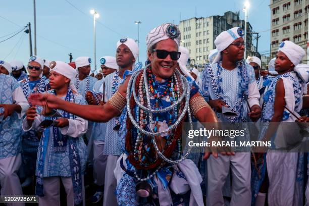 Revellers attend the parade of the street carnival group Afoxe Filhos de Gandhy in Salvador, Bahia state, on February 23, 2020. - Afoxe Filhos de...