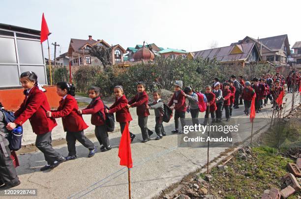 School children arrive on the first day in Srinagar, Kashmir on February 24, 2020. Schools across the Kashmir valley reopened after remaining closed...