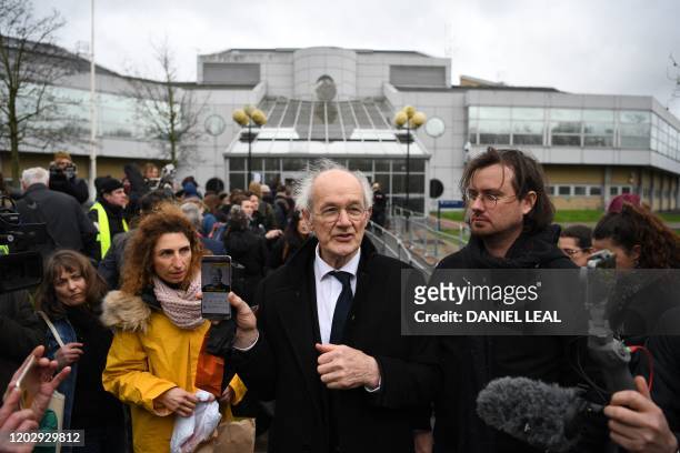 John Shipton , father of WikiLeaks founder Julian Assange, and Gabriel Shipton Assange's brother, holds up a smartphone playing paying a video of...