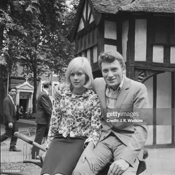 French husband and wife singers Sylvie Vartan and Johnny Hallyday posed together in Soho Square, London on 27th June 1965.