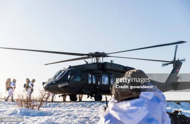 turkish army soldiers boarding a sikorsky uh-60 black hawk military helicopter - sikorsky helicopter stock pictures, royalty-free photos & images
